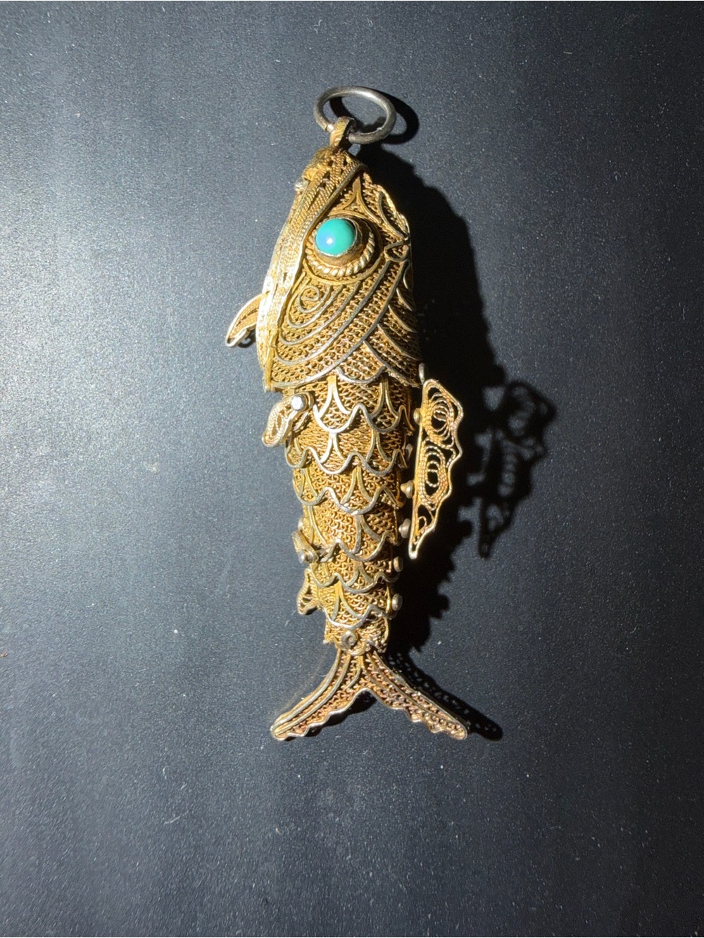 Vintage articulated filigree fish pendant, gold-tone silver, turquoise eye